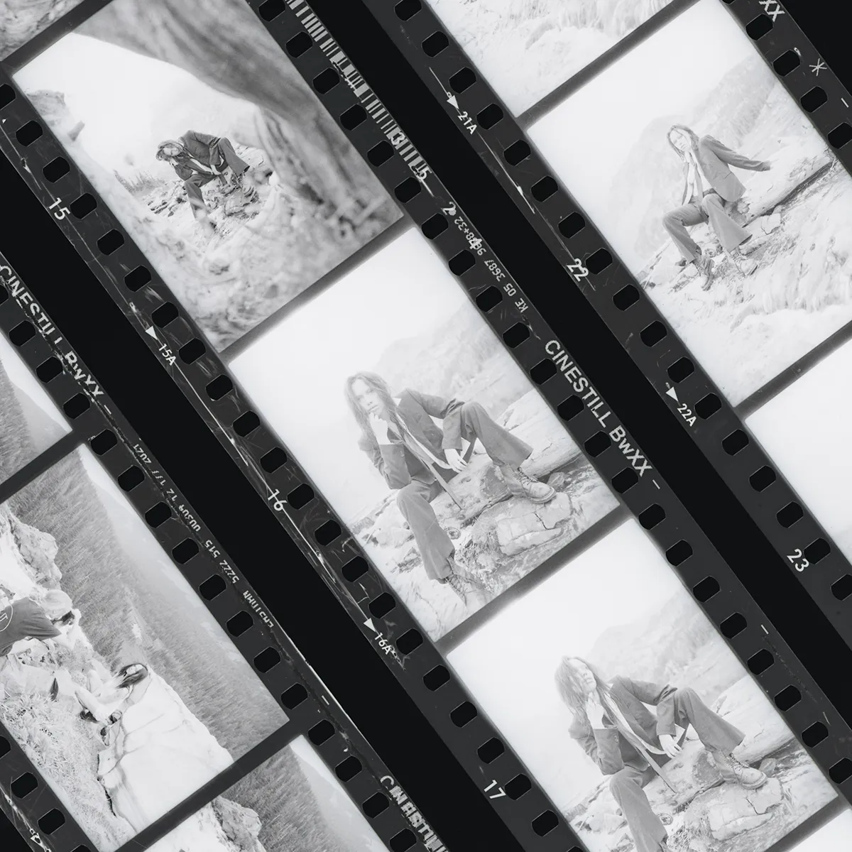 Film contact sheet of medium-format frames showing a model on a rocky shore